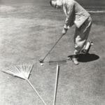 man using tools laid on ground to increase his putting ability in golf