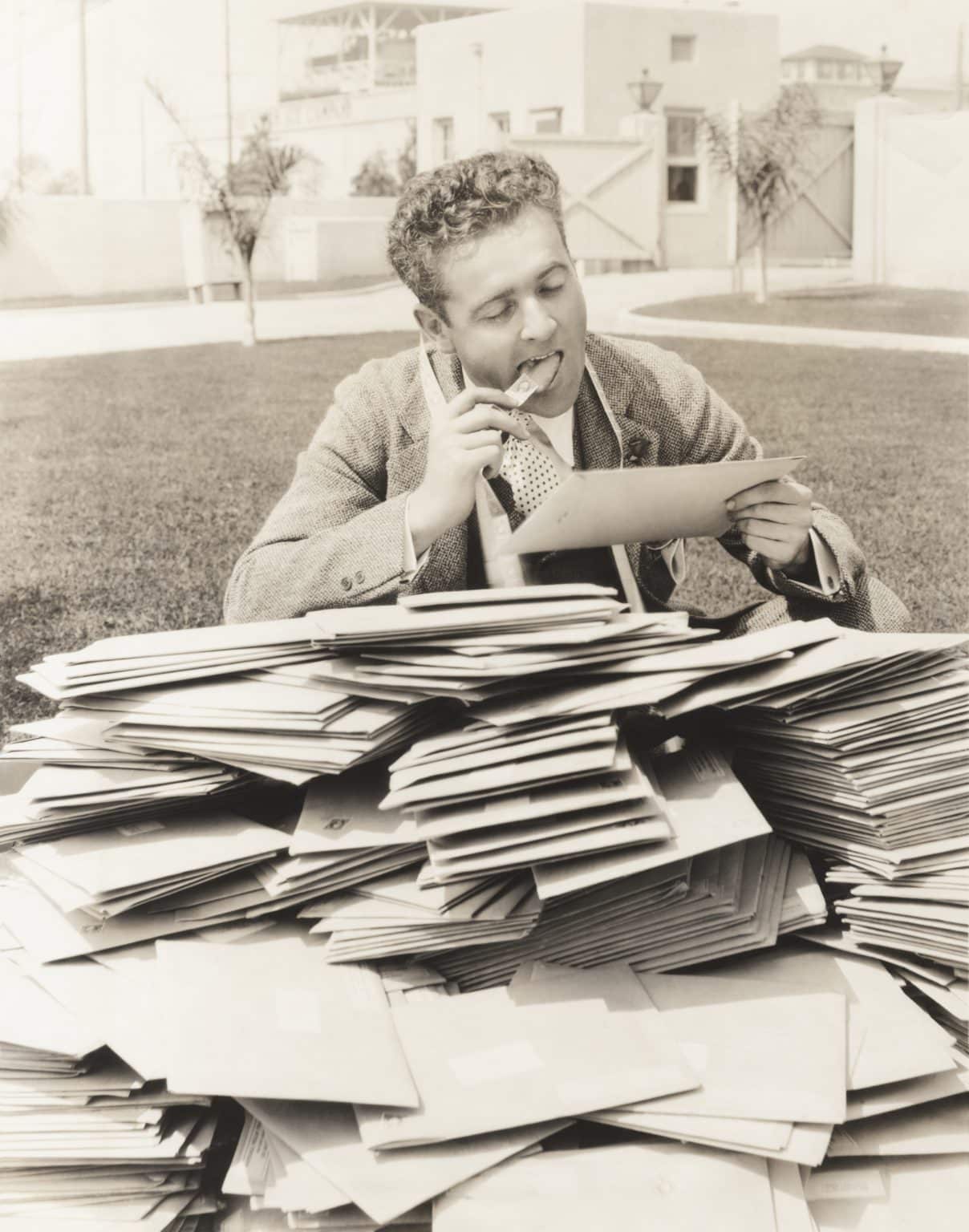 man reading a pile of letters - a metaphor for email engagement