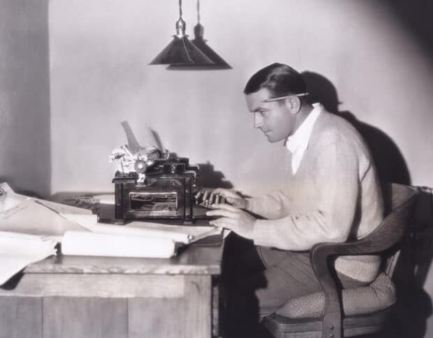 Man writing using typewriter to write goal statement