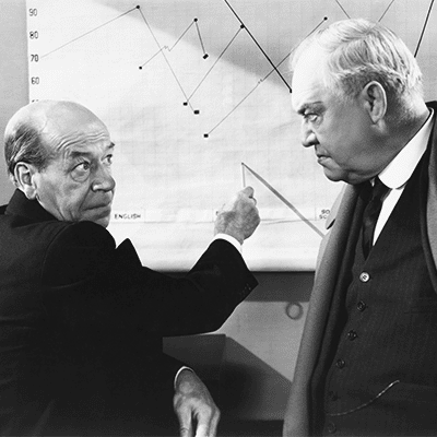 Two old men looking at a hand drawn chart - vintage image